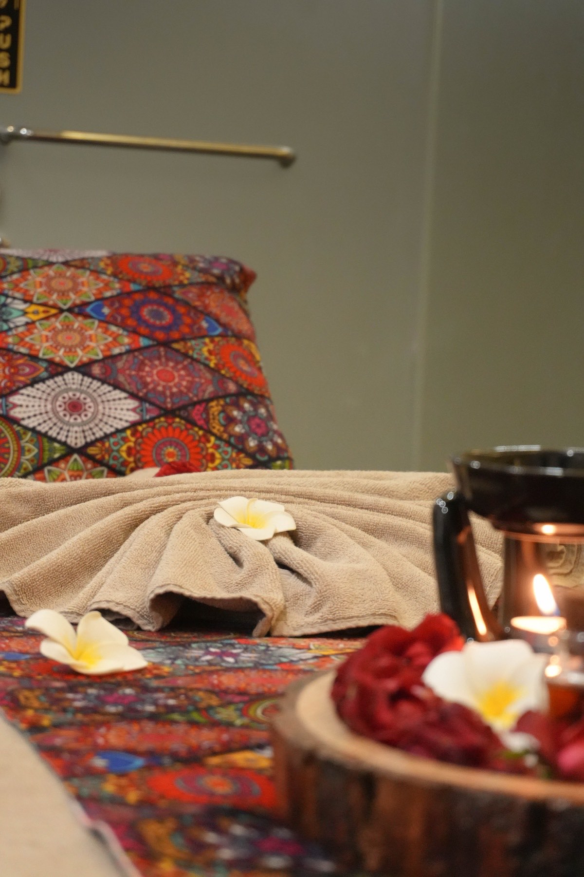 A treatment room prepared with flowers and candles